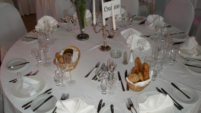 Parzer-Reibenwein Catering Service, © Parzer-Reibenwein Elegant table setting with white tablecloths, candlesticks and bread baskets.