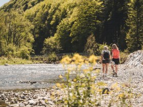 Two women take a break by the water.