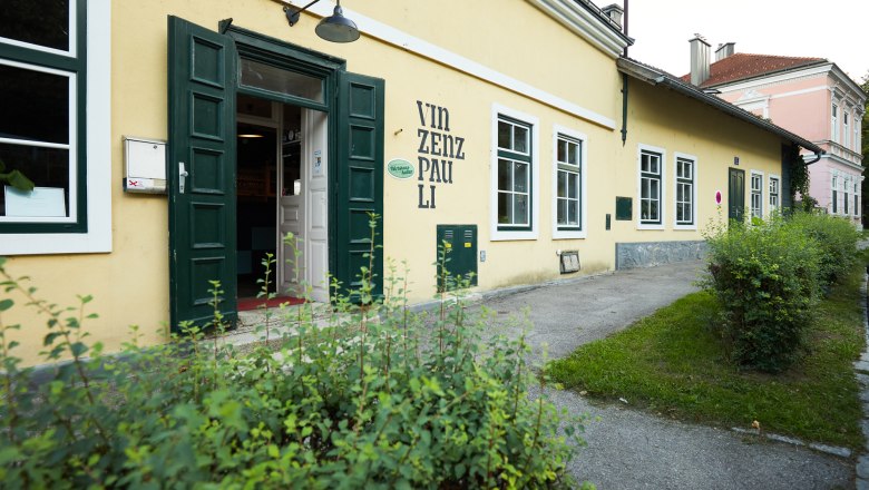Exterior view of a yellow building with the inscription 'Vinzenz Pauli'.