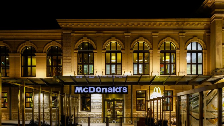 McDonald's restaurant in a historic building at night.