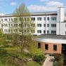 Inner courtyard of the Bildungshaus St. Hippolyt with trees and buildings.