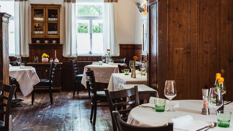 Cozy pub with wooden furniture and laid tables.