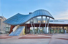 Entrance to the Museum Nieder&ouml;sterreich with modern architecture and curved glass roof.