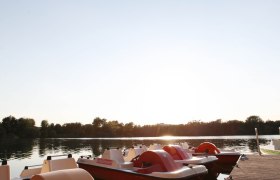 Pedal boats on the jetty at sunset.